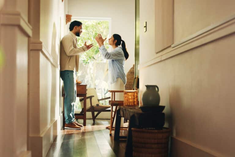 Frustrated couple, hallway or home with argument, fight or conflict for disagreement or breakup. Angry, man and woman shouting with dispute for toxic relationship, cheating affair or divorce in house.